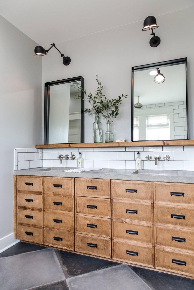 Bathroom with rustic wood vanity with checkerboard concrete floors