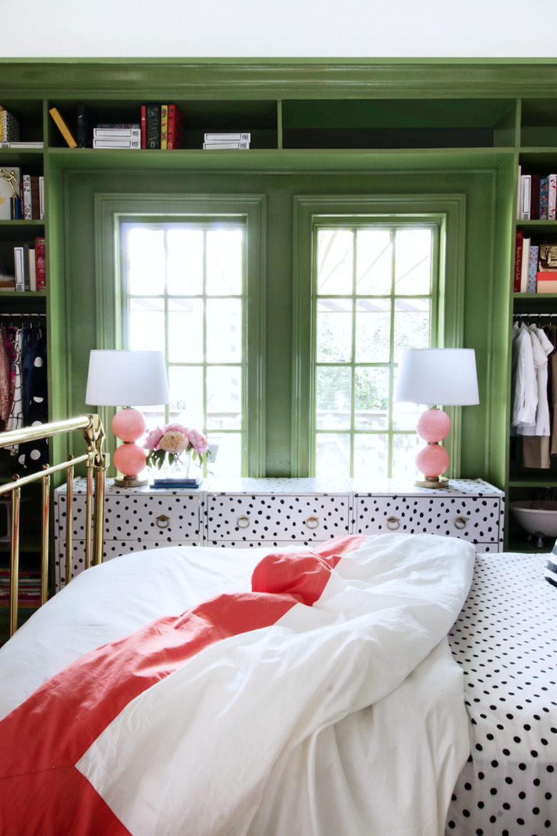 Green bedroom with built-in shelving