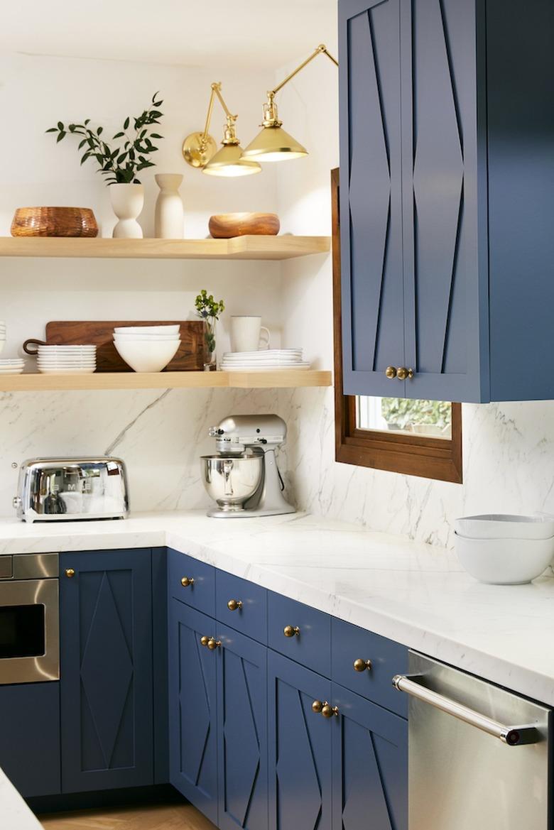 navy blue and white l-shaped kitchen with open shelving