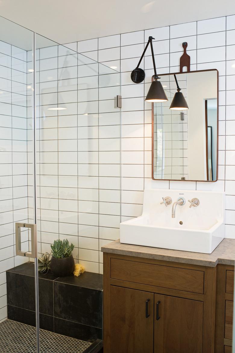 Photo of bathroom with glass walk-in shower with a bench.