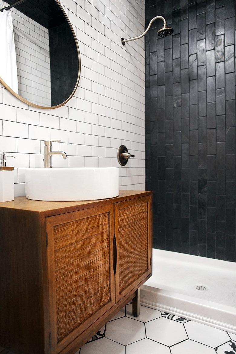 Photo of bathroom with black-and-white tiled walk-in shower.