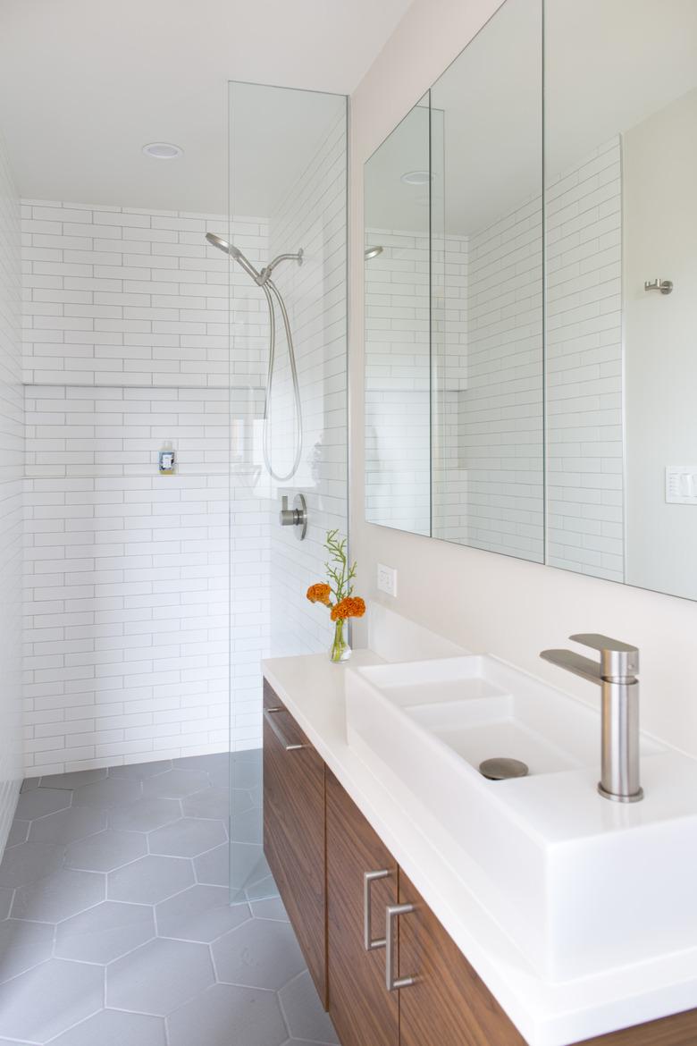 white tiled bathroom with glass walk-in shower