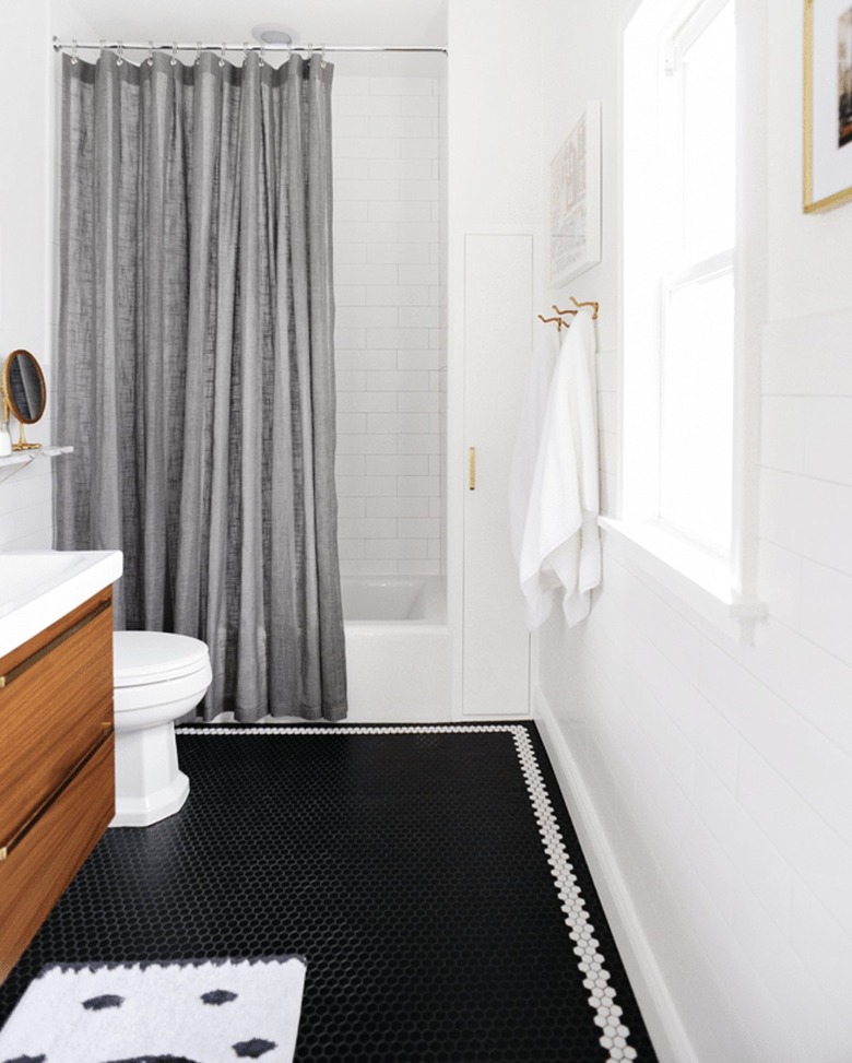 gray shower curtain in white bathroom