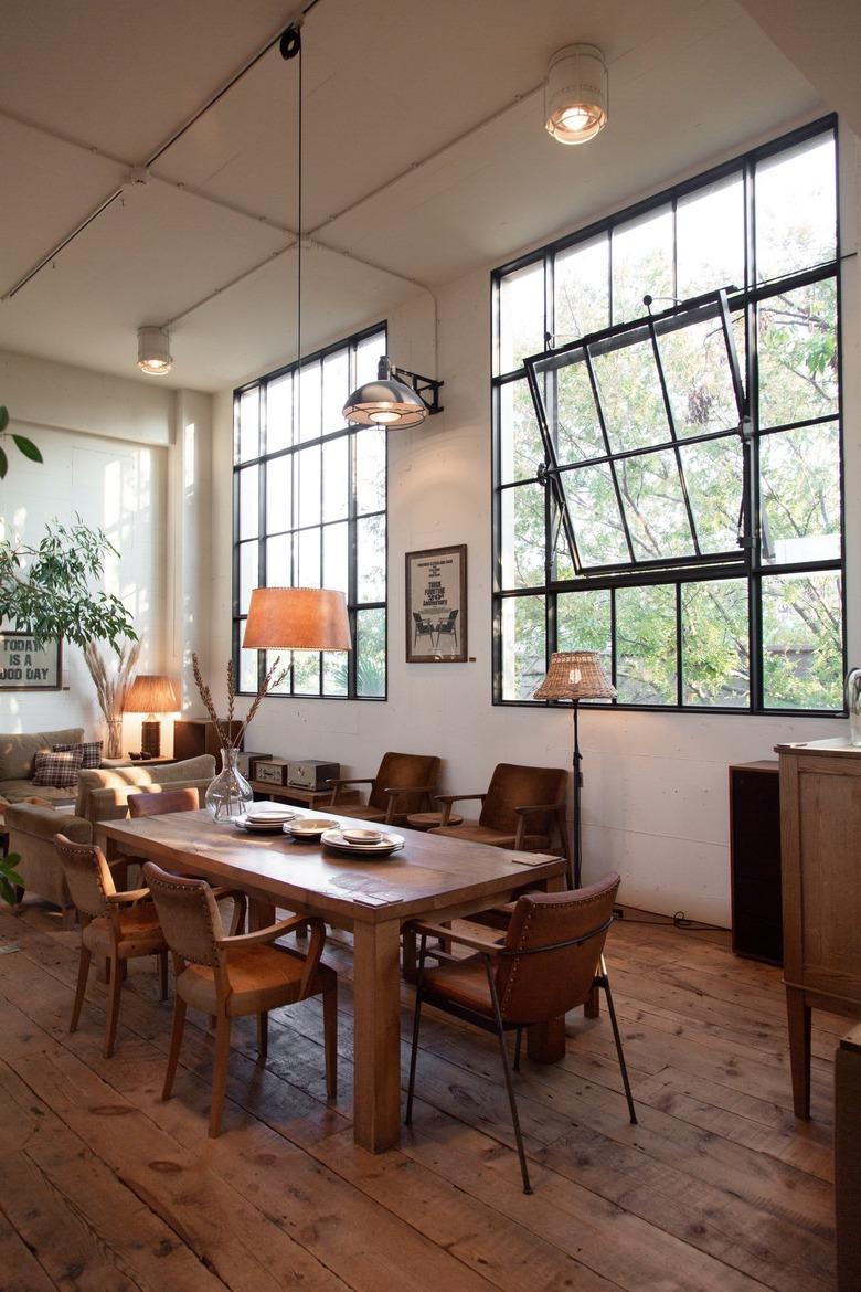 a solid wooden dining table and brown leather chairs