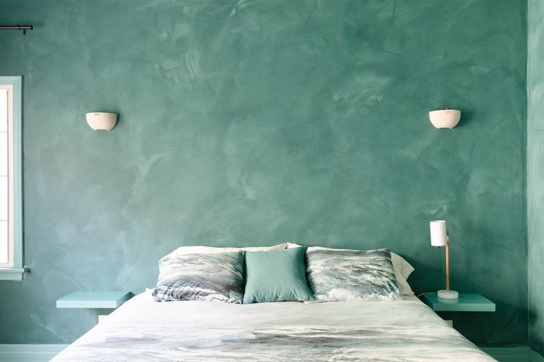 green plaster walls in bedroom with green bedding