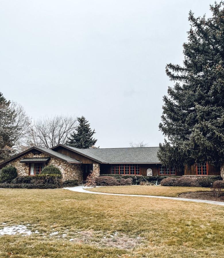 A 70s style ranch house with a stone exterior