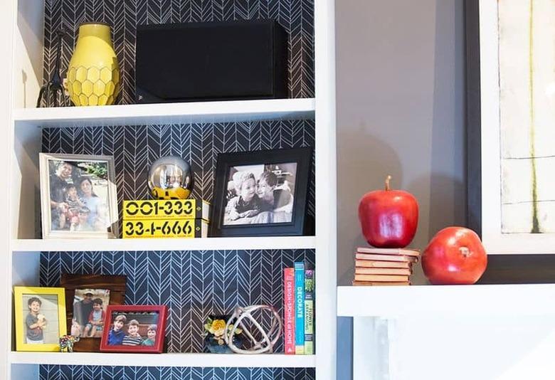 bookcase back lined in removable wallpaper