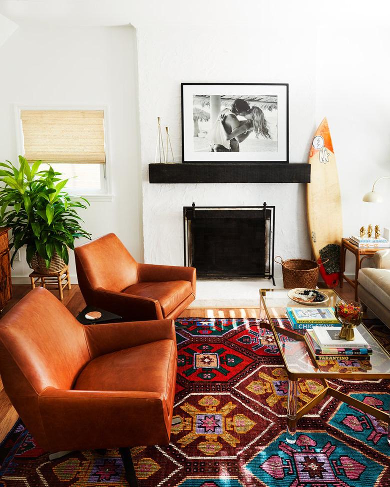 beach chic living room with black wood mantel and white brick surround at fireplace