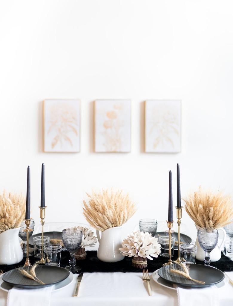 fall tablescape with bundles of dried wheat in pitchers