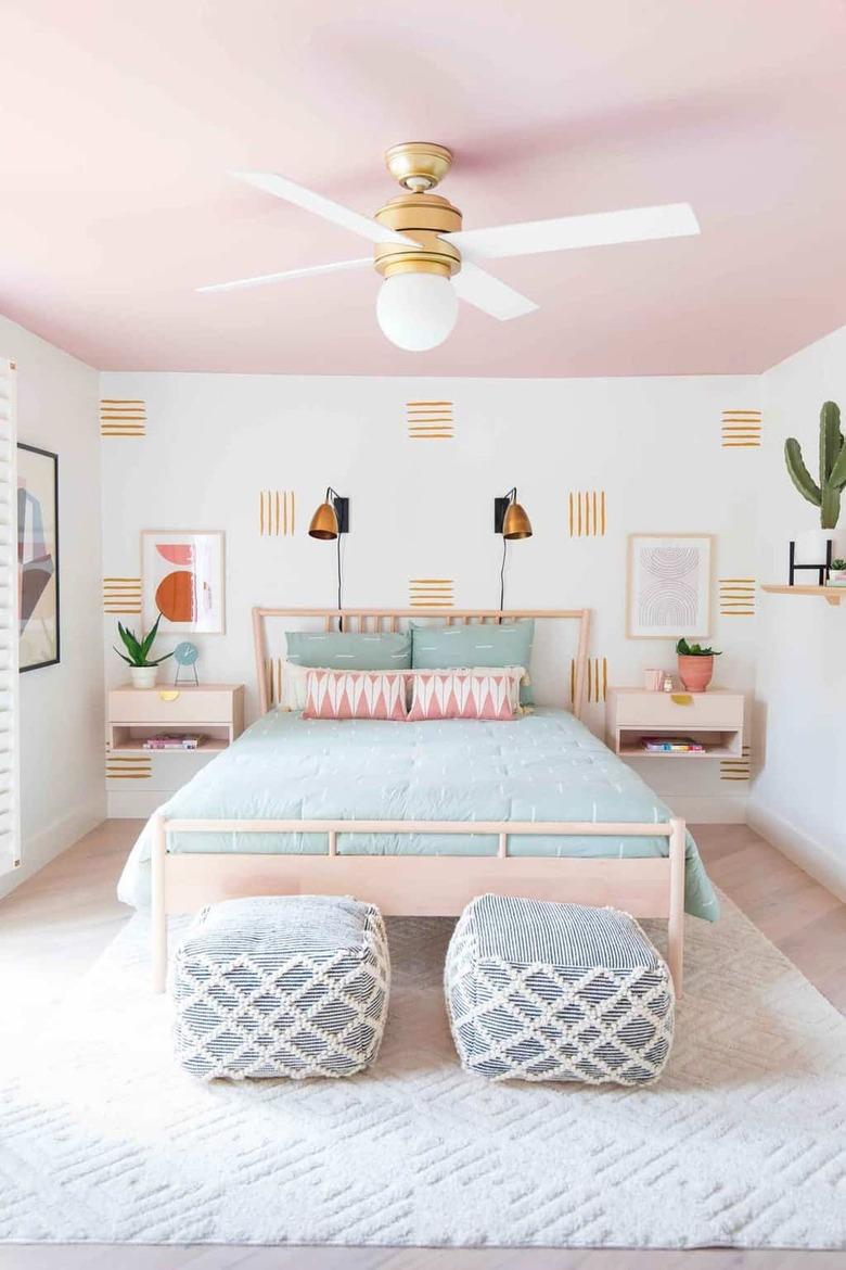 Modern bedroom with pink ceiling and hand painted accent wall.