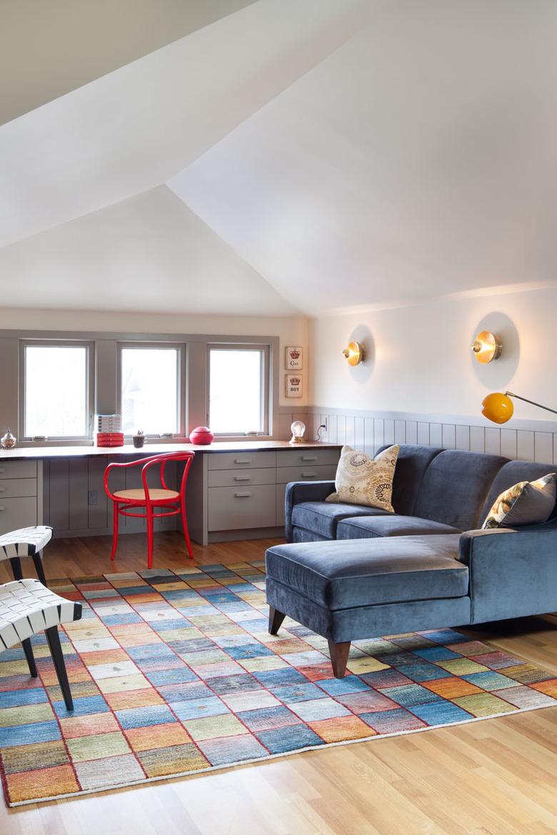 attic living room with built-in desk and colorful furnishings