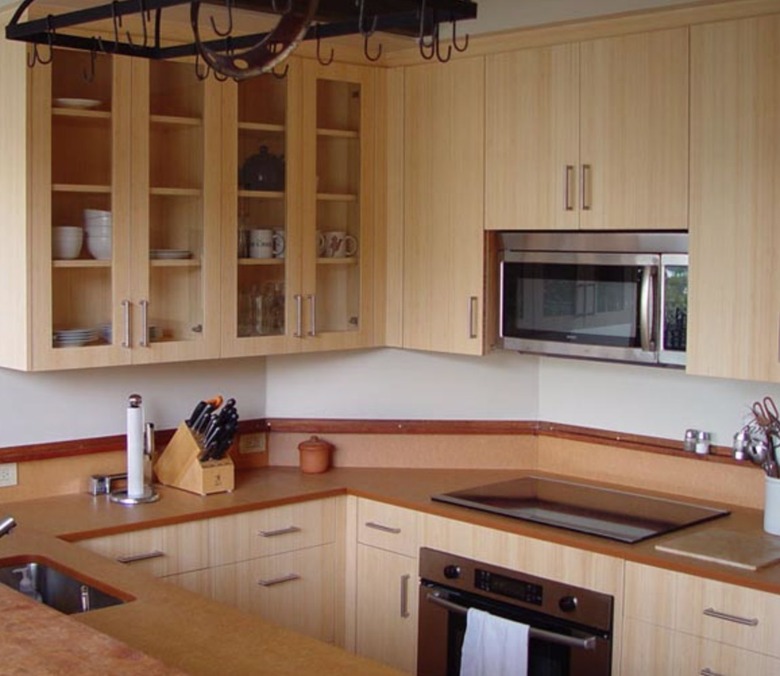 Kitchen with bamboo cabinets, microwave, electric cooktop.