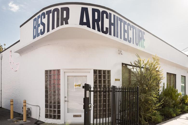 Streamline moderne entrance to Bestor Architecture with white exterior