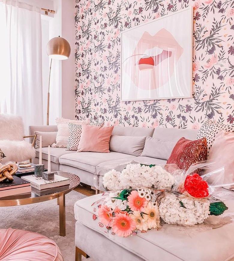 Living room with floral wallpapers and grey couch