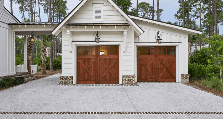 Cherry wood barn garage doors with white exterior