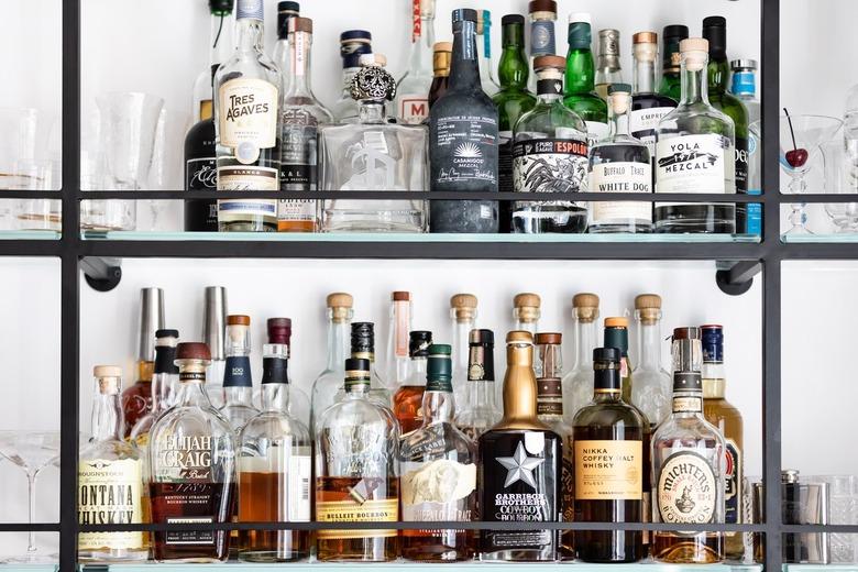 alcohol bottles on metal shelves