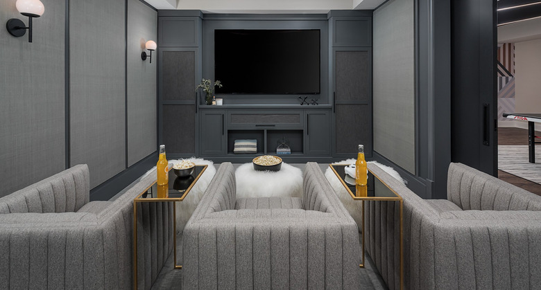 basement ideas with Gray lounge chairs, gray walls and flat screen tv in screening room.