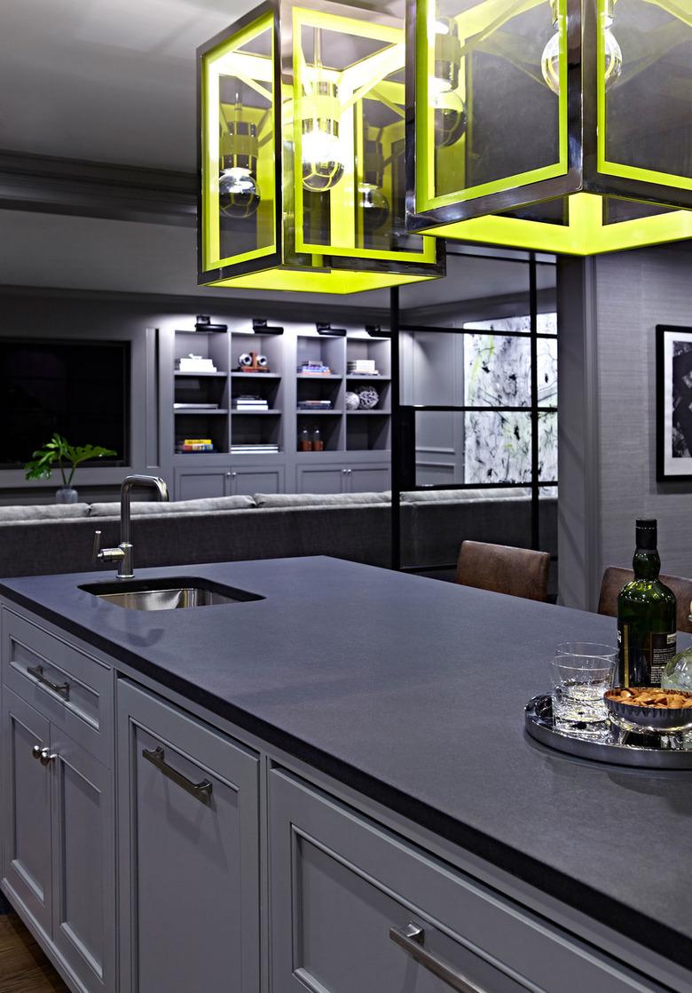 monochromatic basement kitchen with yellow lights