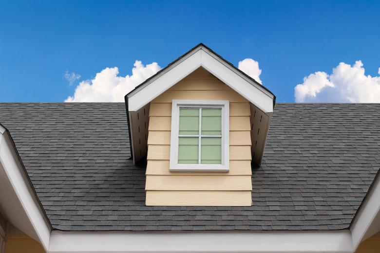 fake window on garret house and roof shingle wirh blue sky background. Asphalt Shingles or Bitumen Tiles.