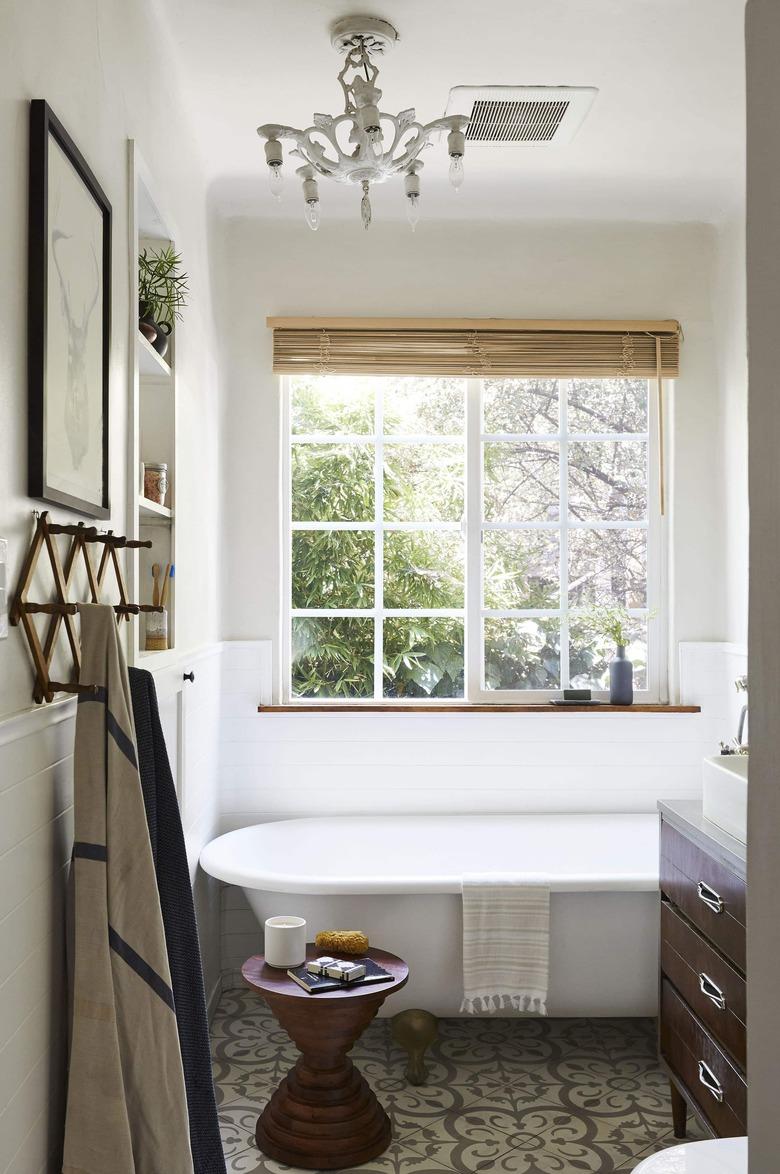 bathroom chandelier lighting idea with vintage fixture hanging above tub