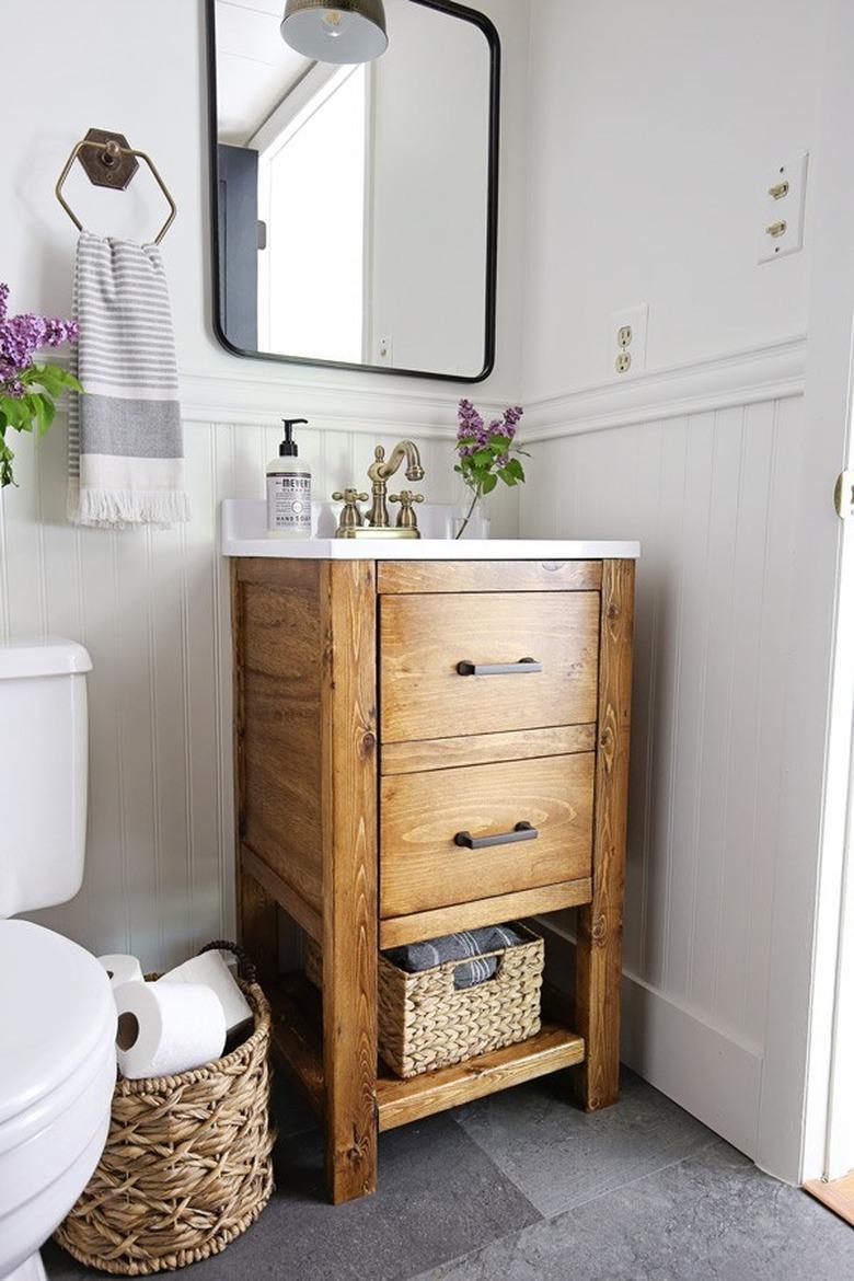 small wood vanity cabinet with bathroom sink