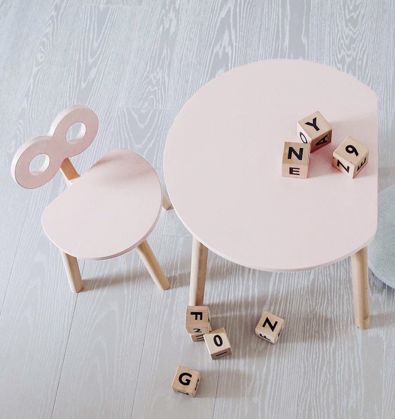 Pink table and chair set with a vinatge wind up toy look