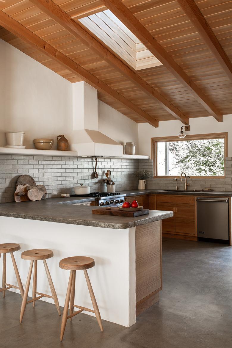 white kitchen with wooden ceiling