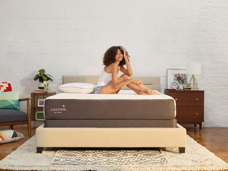 woman sitting on cocoon by sealy memory foam mattress