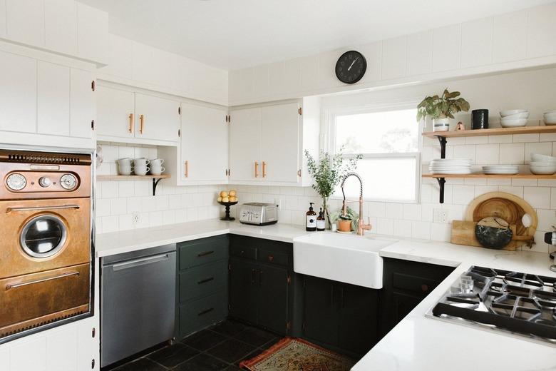 White and dark green kitchen with midcentury copper oven