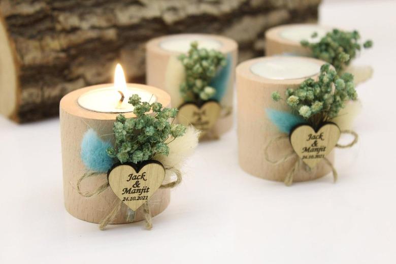 Four brown candles with heart-shaped tag and dried flower decoration