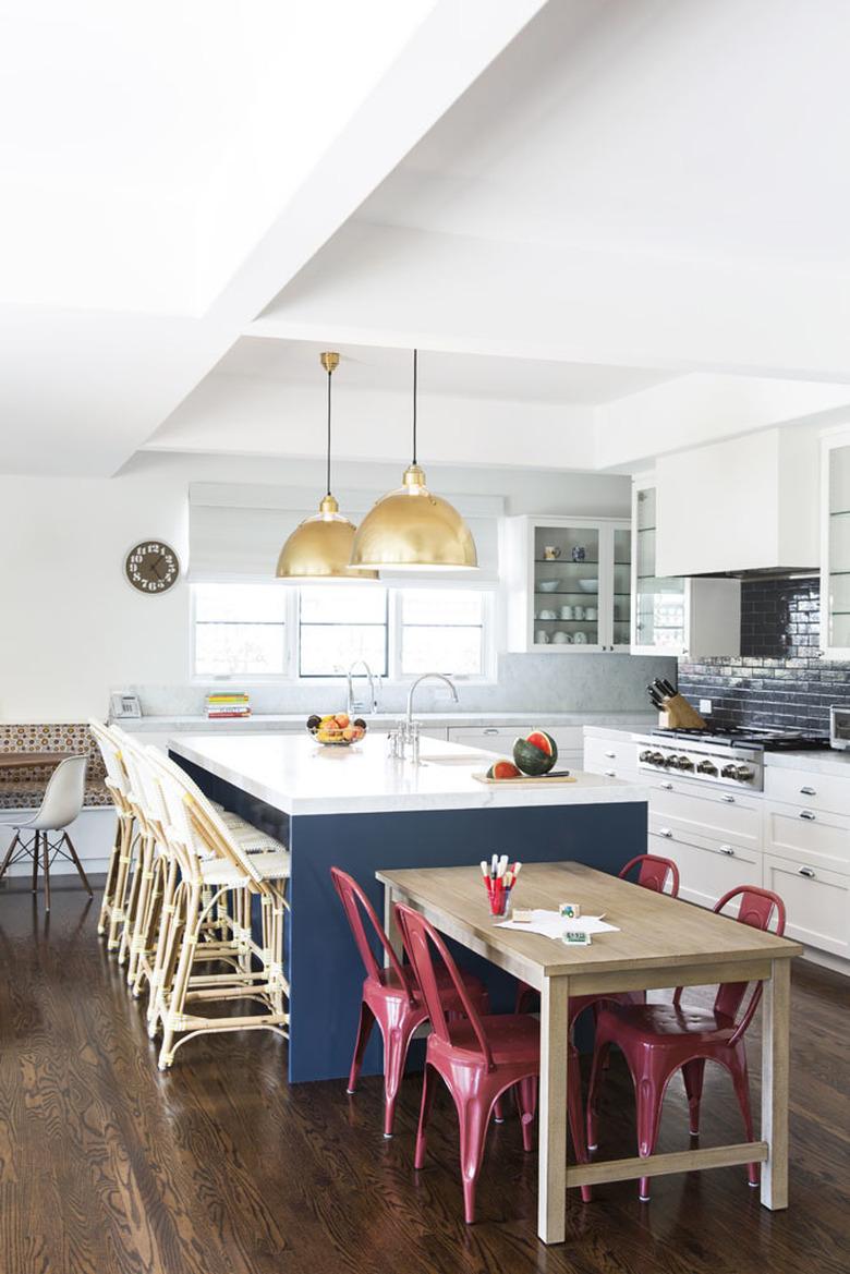 navy blue kitchen backsplash idea with dome shaped brass pendant lights over island