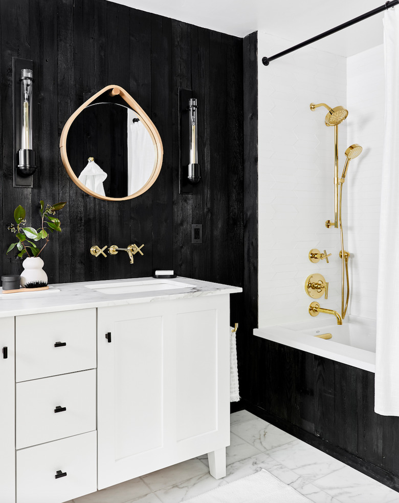 Black bathroom backsplash idea with stained wood walls, marble floor