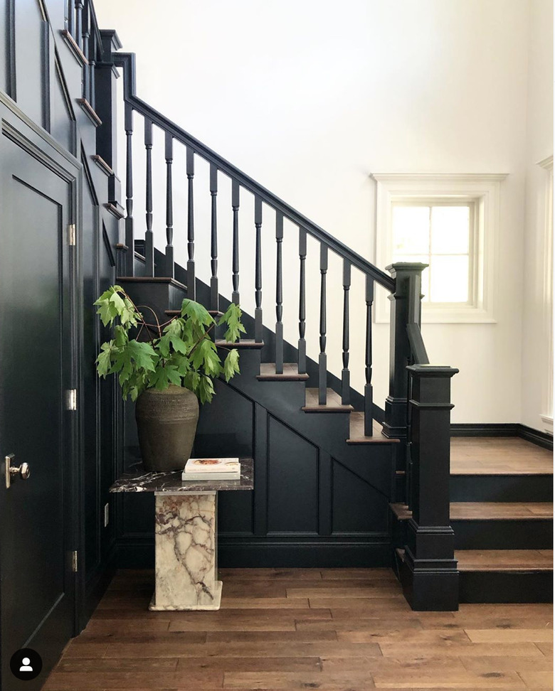 traditional black stair railing with wood steps