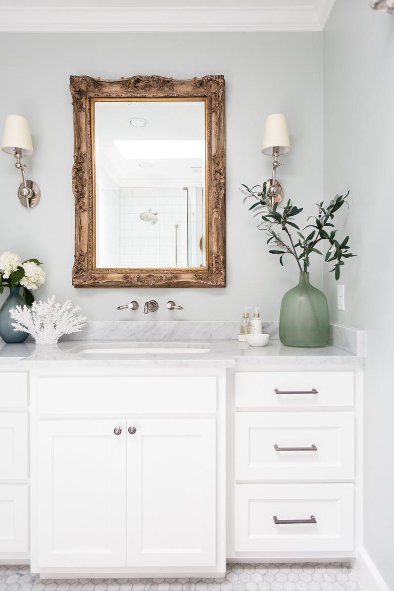 light blue paint color bathroom with white vanity and mirror