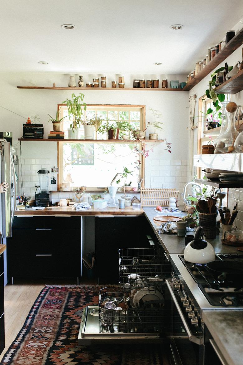 bohemian kitchen with open shelving and black cabinets