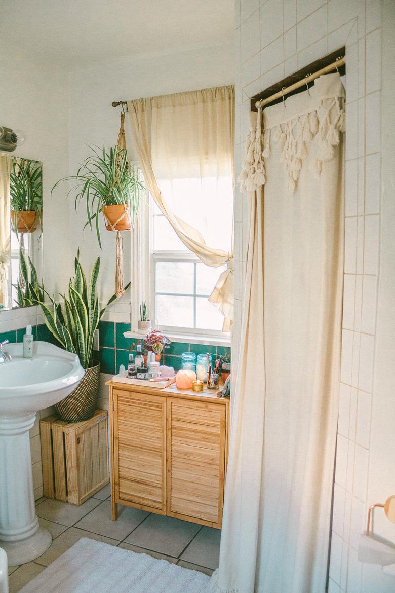 Boho Bathroom Storage in small boho bathroom with bamboo vanity