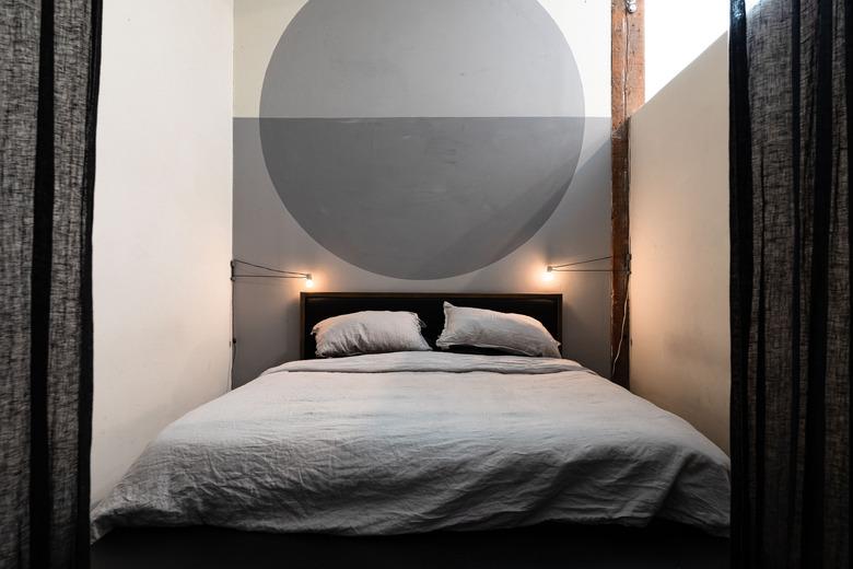 gray calming colors in minimalist bedroom with gray circle accent wall