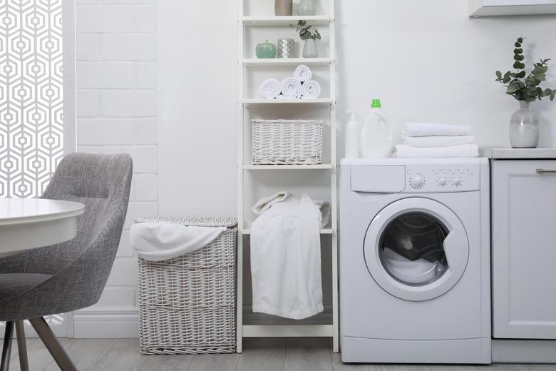 Kitchen interior with washing machine and stylish furniture