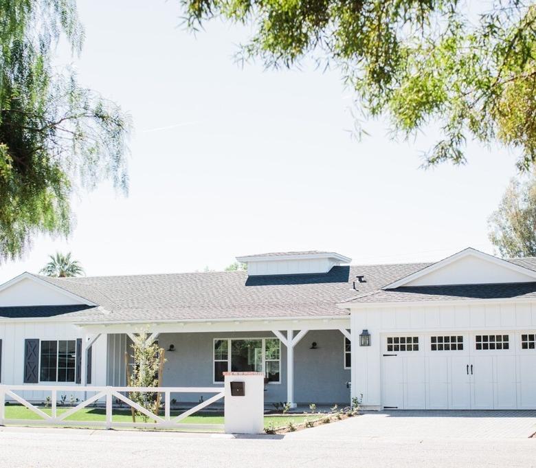 white house exterior with carriage style garage doors