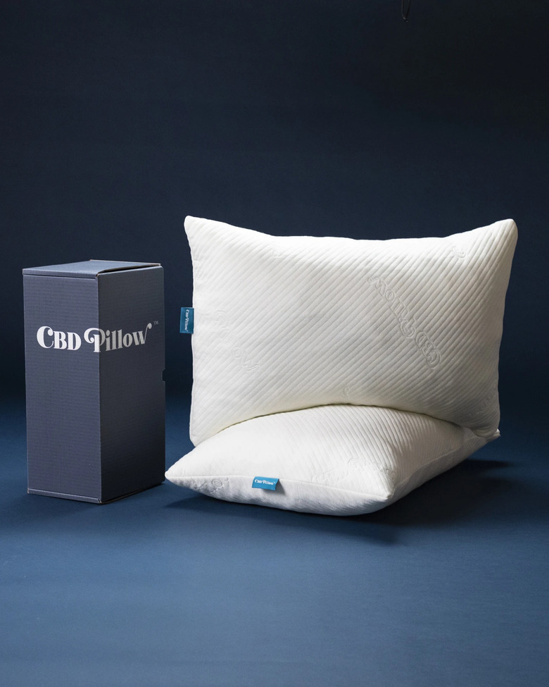 box with text CBD pillow and two pillows nearby