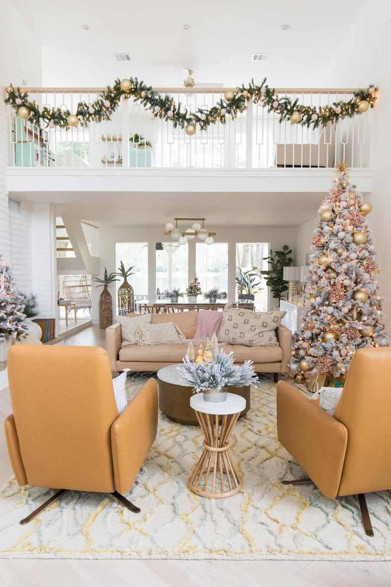 Modern 70s living room with yellow chairs and Christmas decor in warm colors