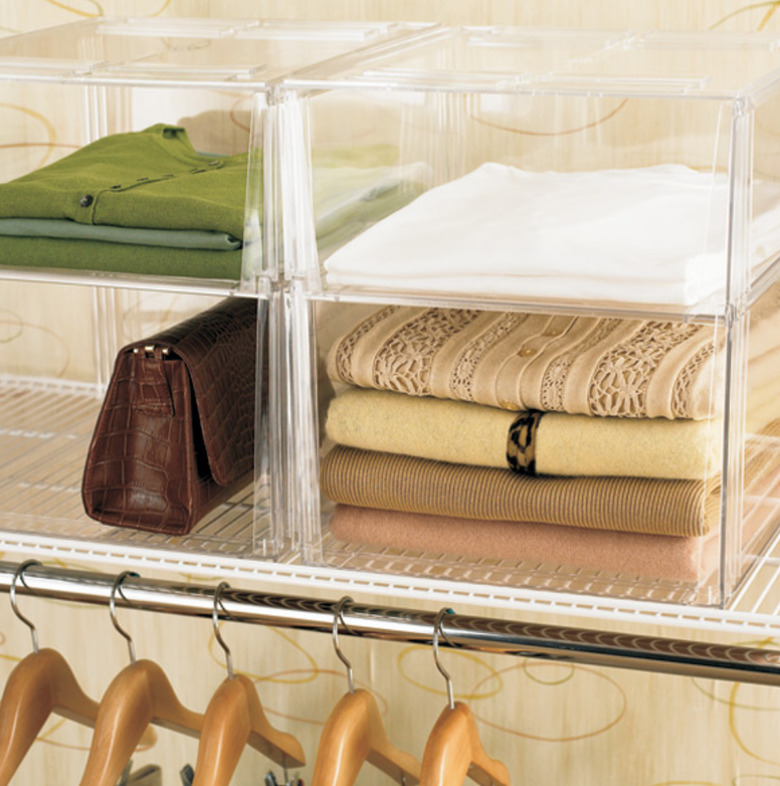 Closet Organizer with Clear plastic storage bins, sweaters, purse.