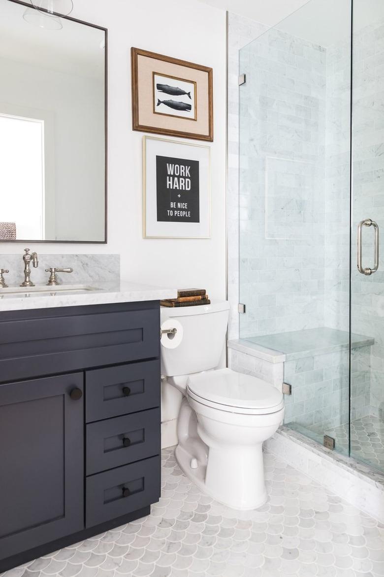 Gray and white fish scale tile coastal flooring idea in bathroom with black vanity