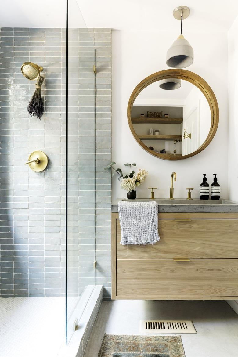 contemporary shower with blue green tiles and wooden vanity