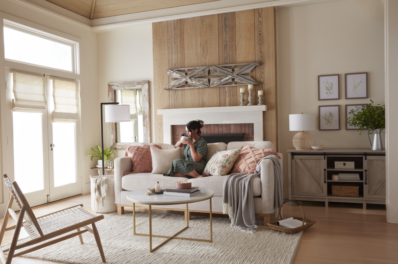 woman sitting on couch in well-decorated living rom