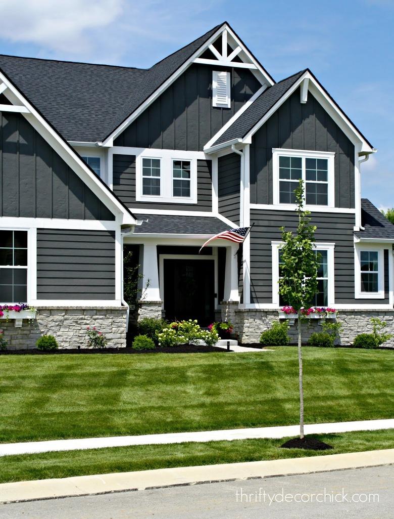 Dark gray Craftsman home exterior with white trim and gables