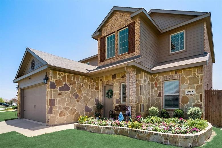 Two-story brown house with stone exterior