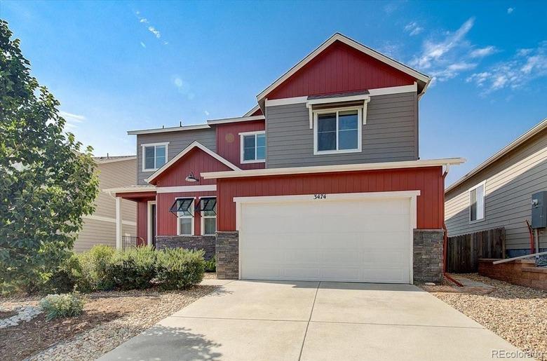 Red house with white garage door