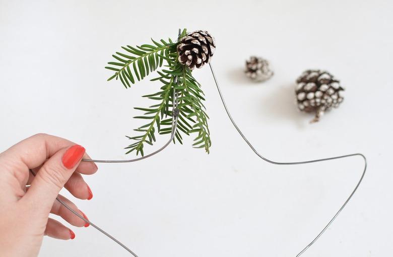 Star-shaped wire wreath with wintergreens and pinecones