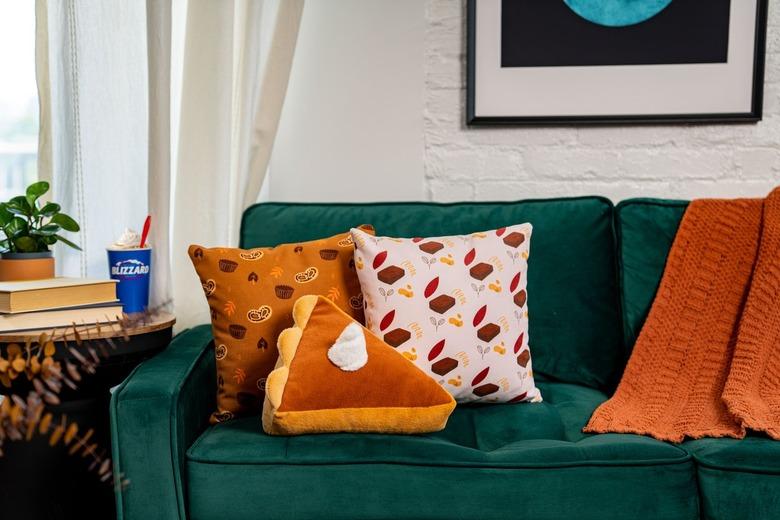 pumpkin pie pillow on emerald green couch